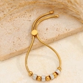 Bracciale a sfere dorato regolabile con pietre bianche e design a catena serpente - Quattro Diamanti Di Fango Dorato