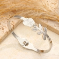 Polished silver rose bangle with crystal leaves on a natural stone surface - Steel