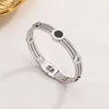 Silver triple-strand cable bangle featuring Roman numeral dial with black center inlay - Steel
