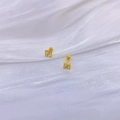 Detailed macro view of 18K gold plated square stud earrings with FF pattern and screw backs - Double F Letter Square Style / Gold