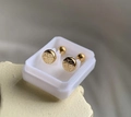 Macro shot of 18K gold plated steel stud earrings with Fú character and ball screw backs - Gold