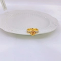 Macro detail of Elizabeth II gold coin ring with zircon inlay on polished metal - US 6 / Gold