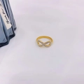 Detailed macro view of an 18K gold plated infinity ring with sparkling white zirconia stones - Ring Gold #6 / Size 6