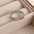 Titanium steel ring with traditional Chinese coin design on beige velvet display - Steel / US 6