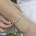 Ethnic style anklet featuring light blue turquoise chips and white beads on ankle - Blue Natural Crushed Stone Hand Beaded Style (0718) / Blue