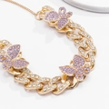 Detailed macro view of a gold Cuban chain anklet featuring purple crystal butterflies - Gold Purple Rhinestone