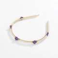 Detailed view of floral headband with white pearls and purple bead flowers on gold metal - Purple