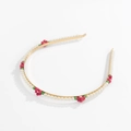 Macro detail of bead-woven daisy flowers and imitation pearls on a golden metal headband - Rose Red