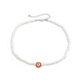 Detalle de collar de cuentas blancas con dije de flor naranja y letra S grabada - Blanco/Naranja / Collar