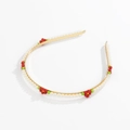 Detail of a gold headband featuring white faux pearls and red floral beaded accents - Red