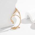 Detailed close-up of a golden hollow elf ear cuff featuring artistic streamlined outlines - Left Ear Gold Elf Style (2641)