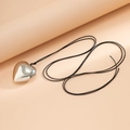 Detailed close-up of a polished silver heart pendant on a black adjustable cord - White K Wax Thread (5482)