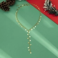 Gouden Y-vormige ketting met sterrenhangers op een feestelijke kerstachtergrond - Gouden Y-Vorm Ster Ketting (4754)