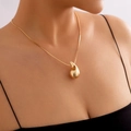 Polished gold teardrop pendant necklace with a sleek snake chain on a female model - Teardrop Necklace (5808) / Gold