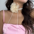 Detailed macro view of an elegant champagne organza flower choker with a white lace-up ribbon - Off White