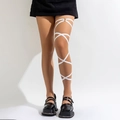 White elastic cross leg chain harness with metal ring detail on female model - White