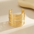 Macro shot of minimalist gold-plated multi-layer wire cuff bracelet with brushed texture - Multi-layer Wire Wrap (2212) / Gold