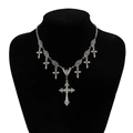 Gothic silver cross pendant necklace with red beads on a black mannequin display - Silver Flower Cross