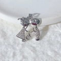 Detail of silver Cupid arrow pendant with micro-paved zircons on a white plush background - Silver Kissing Couple (4)