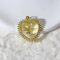 Macro shot of gold-plated heart pendant with micro-paved zircons and a flying bird detail - Gold Pave Zirconia Bird Heart Style (6)