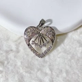Silver heart pendant with wing motif and sparkling cubic zirconia stones on white fabric - Silver Wings With Inner Pendant Heart Style (3)
