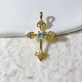 Macro shot of a vintage gold cross pendant featuring central oval clear gemstones - Gold Tone with Clear Stone