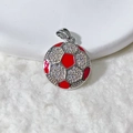 Macro shot of silver football pendant with white cubic zirconia and red enamel details - Red And White Football Style (3)