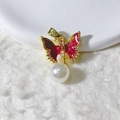 Detailed view of a gold butterfly pendant with red enamel wings and a hanging white pearl - Red Butterfly Artificial Pearl Pendant Only (Without Chain) (2)