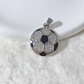 Macro shot of silver football pendant with white cubic zirconia and black enamel textures - Black And White Football Style (4)