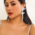 Long white ribbon bow earrings with faux pearl tassels shown on a female model - Double Bowknot Pearl Long Drop Earrings / White (3021)