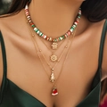 Close-up of layered Christmas necklaces with clay beads and festive golden pendants on neck - Specification / Gold (4460)