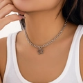 Close-up of minimalist silver star pendant necklace with delicate chain on model - Hollow Pentagram Necklace (6083) / Silver Style (6083)