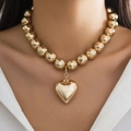 Golden chunky bead necklace with large 3D heart pendant shown on model neck - Style 02 Gold 6070