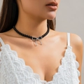 Elegant black beaded choker necklace with a sleek silver bow pendant on a model - Specification / Silver Black (6243)