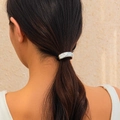 Black elastic hair tie with curved silver metal piece shown on a ponytail - Curved Metal Hair Tie / Silver Ponytail Clip (0557)