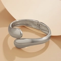 Detailed close-up of polished silver teardrop bangle with hinge and mirror finish - 03 Silver Bangle (2427) / Silver
