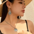Bohemian silver necklace and earrings set with turquoise sun pendant on model - Round Lotus Embossed Shape (5075)