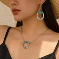 Bohemian silver necklace and earring set with turquoise stones on a model - Spiral Vortex Shape (5076)