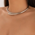 Polished silver torque necklace with streamlined teardrop ends on a fashion model - Silver (Choker)