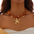 Detailed view of beaded ocean necklace with gold starfish, seahorse and turtle charms - Orange Necklace(6675)