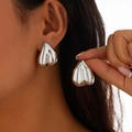 Détail d'une boucle d'oreille cœur argentée géométrique portée par un mannequin pro - Style Argenté (3325)