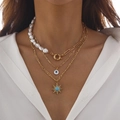 Close-up of layered necklace with irregular pearls, evil eye and sun pendants on a model - Gold Style 06 (5309)