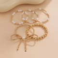5-piece layered gold bead and white pearl bracelet set with an elegant bow accent - 5-Piece Bowknot Artificial Pearl Bracelet Set / 5 Pieces Pack / Gold