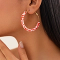 Close-up of bohemian gold hoop earrings with red and white polymer clay heishi beads - Red And White Large Hoop (3423-K8)