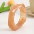 Close-up of a square apricot marble resin bracelet with smooth geometric contours - Milk Tea