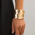 Minimalist wide gold bangle featuring irregular wavy metal texture and polished finish - Wide Wave Hammered Bangle (2596) / Gold