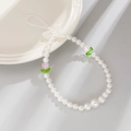 Macro view of beaded phone strap with pink tulips, faux pearls and a delicate white bow - White + Pink