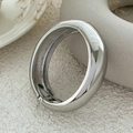 Close-up of polished silver metal bangle showing hinge and spring clasp detail - Chunky Tubular Bangle (2609) / Silver