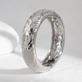 Detail view of the silver hammered texture and irregular wave finish on this wide bangle - Silver (2543)
