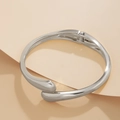 Macro detail of silver irregular metal bracelet with spring hinge and waterdrop ends - Silver Bracelet (2426k1)